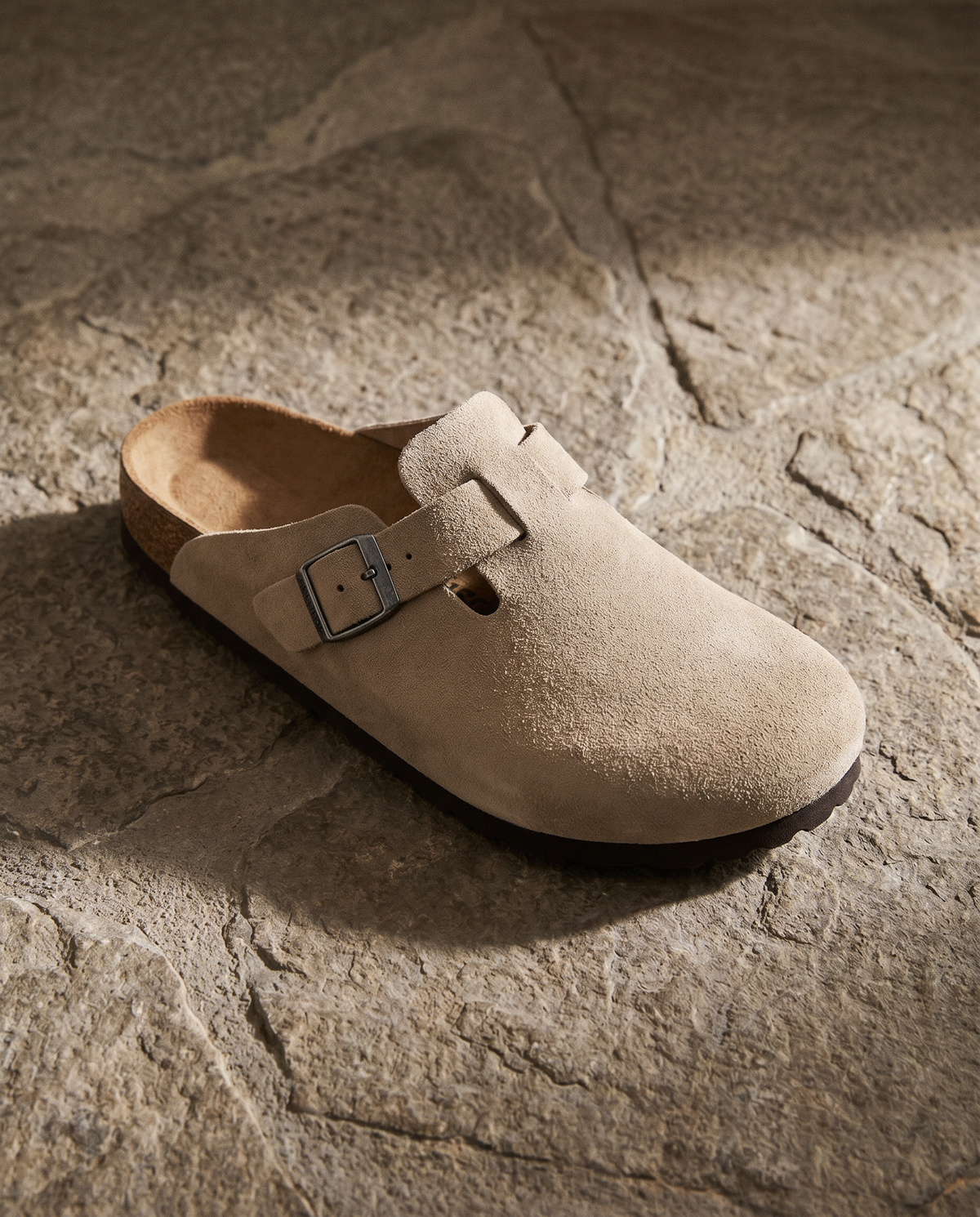 Lacta Clogs Sand Suede Clog shown on stone paver in real-life lifestyle setting