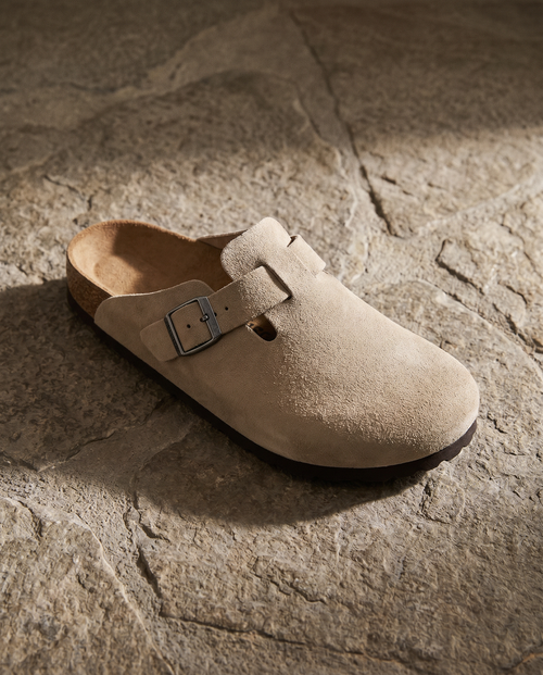 Lacta Clogs Sand Suede Clog shown on stone paver in real-life lifestyle setting