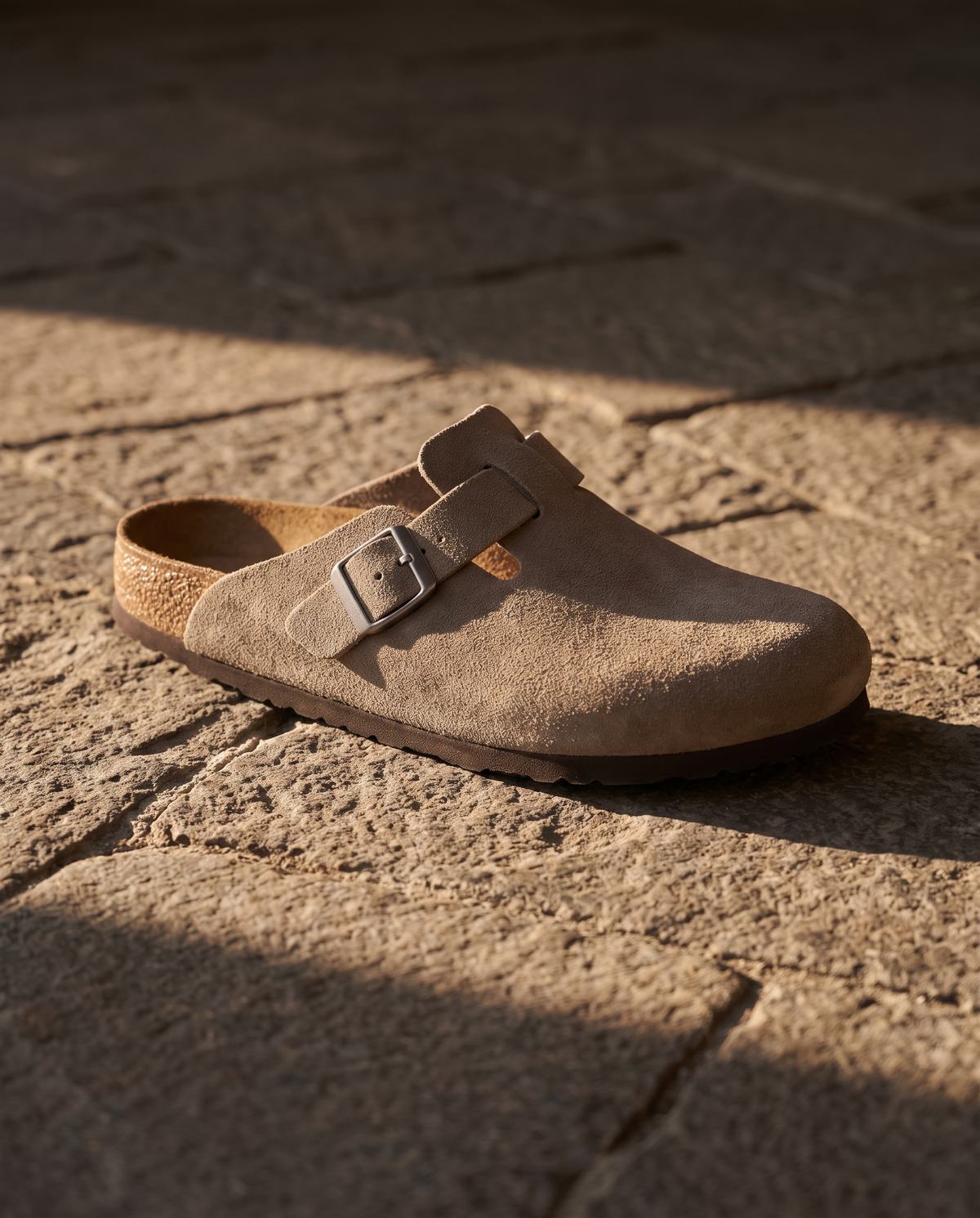 Lacta Clogs Stone Suede Clog shown on stone paver in real-life lifestyle setting