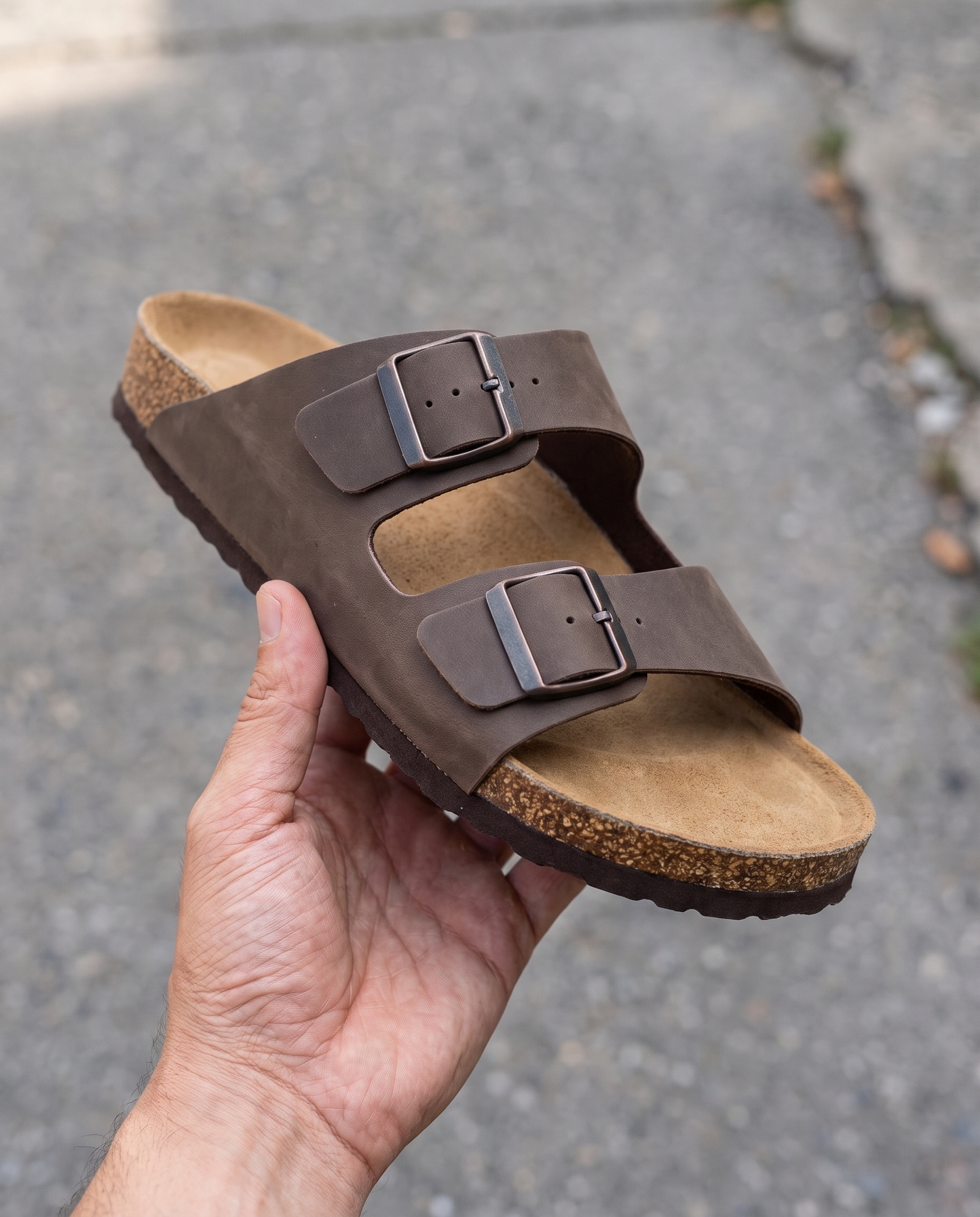 Lacta Men's Sandals Brown held in hand, real-life lifestyle photo